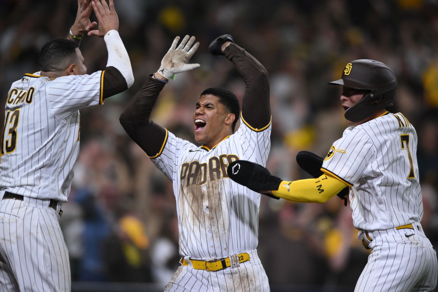 Padres star Juan Soto lifts his hands in the air in celebration